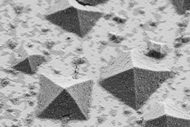 The process of how crystals form on a flat surface, as shown in this electron microscope image, has been difficult to study in detail until now.