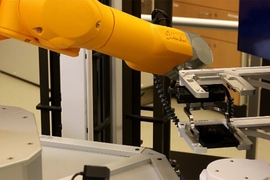 MIT engineers have developed a new system for rapidly analyzing drug absorption in intestinal tissue.  Here, a robotic arm picks up a plate with gastrointestinal tissue from the storage unit for an experiment.