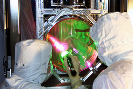 LIGO optics technicians examining one of LIGO’s mirrors