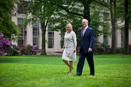 Rafael Reif and Christine Reif walk across the lawn of MIT's Killian Court