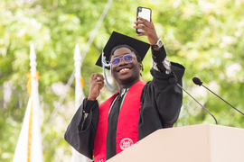 MIT Class of 2022 Class President Temi Omitoogun smiles for a selfie at the podium