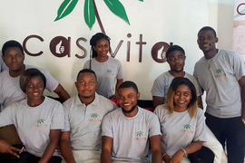 Eight people wearing CassVita t-shirts pose, smiling, in front of a wall with the CassVita logo