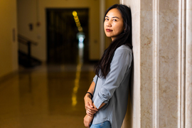 Danielle Li leans against a wall in the infinite corridor