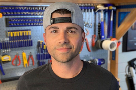 Mark Rober portrait, wood shop and tools in background