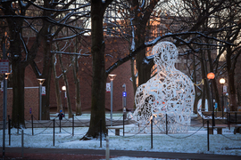 A snowy scene shows Jaume Plensa’s Alchemist sculpture outside the Stratton Student Center.