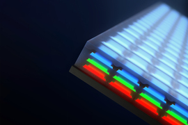 Closeup of a screen has 3 layers of individual LEDs; blue on top, then green and red.