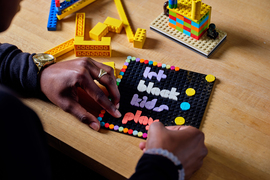 Sadler makes a Lego sign that says, “Let black kids play.”