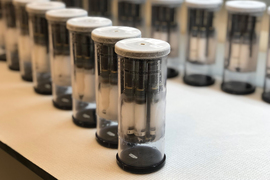 Two rows of vials, and each has smaller chambers with white fluid inside them.