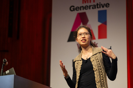 Cathy Wu speaks on stage in front of a banner reading, “MIT Generative AI Week.”