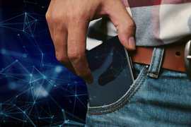 engineering problem solving in the age of ai A cell phone peeks out from the pocket of a person wearing jeans, a belt, and a plaid shirt. In the background and on the cell phone’s screen are stylized connected nodes representing a neural network.