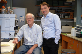 Robert Croy and Bogdan Fedeles pose for portrait inside of laboratory.