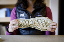 Researcher Sarah Fay holding a 3D printed shoe sole
