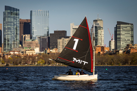 An MIT Sailboat bearing the number 1 on its sail on the Charles River