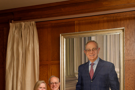 Rafael and Christine Reif stand next to the portrait.