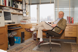 John Little leans back in his chair in his office and smiles.
