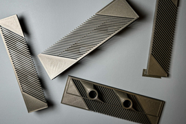 Rectangular 3D-printed pieces have many slits and grooves like a unique comb.