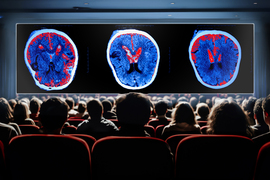 A movie audience watching 3 different brain activity scans on a big screen