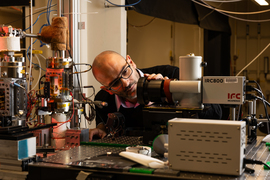 Matteo Bucci looks into infrared camera lens while wired equipment surrounds him