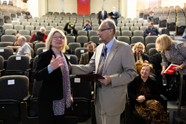 Sally Kornbluth and John Joannopoulos stand in front of seats after award.