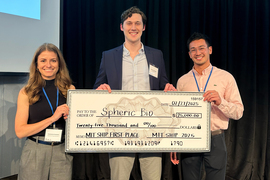 Connor Verheyen poses with $25,000 large check with organizers.