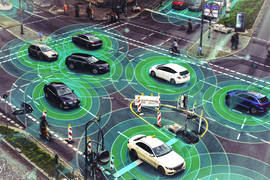 Cars at an intersection with futuristic sensors around them.