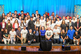 Over 50 people pose for a group photo.
