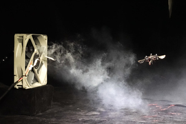 A fan and smoke obscure the microrobot.