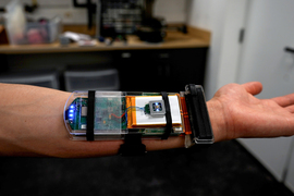 A researcher wearing an ultrasound wristband