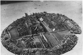 Londoners on garden patch in a tarmac parking lot, circa 1943