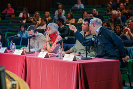 Four judges sit and chat at the event. 