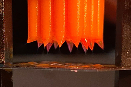 A zoomed-in view of nozzles that emit droplets.