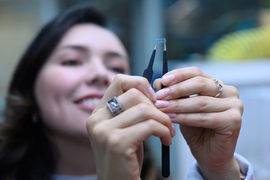 Diana Grass holding a small electronic device