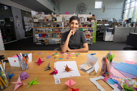 Ila Kumar portrait, seated at a table with craft supplies.