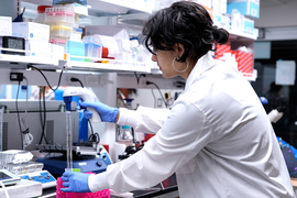 Maheera Bawa uses a pipette in a lab.