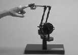 When this PHANToM haptic interface is connected to a desktop computer, it lets the user feel the physical characteristics of the virtual objects she sees on the monitor.