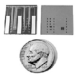 Front (left) and back views of a new microchip for the controlled release of chemicals. The dots between the three large bars (cathodes) on the front are the caps (anodes) covering the reservoirs that hold chemicals. An electrical voltage applied between a reservoir cap and a cathode causes a reaction that dissolves the cap, releasing the chemical. The back view shows the larger openings for each ...