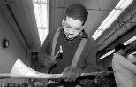 Damian Burke, a sophomore in electrical engineering and computer science, learns about "Brass Instrument Making" as he constructs his own handmade replica of a 17th-century natural trumpet. Among other things, he and other students learned to solder silver, bend tubing, hammer a bell flare and burnish it to shape.