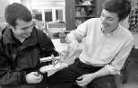 Mechanical engineering sophomore Ben Powers (left) shows his Stirling engine, polished to a shiny hue and the first to be completed and work well, to Associate Professor Douglas Hart, who oversaw the IAP activity in which students built the engines.