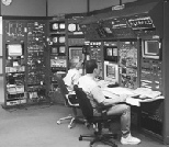 Assistant Operations Group Leader Larry O'Brien (right) and Chief Operator Larry Longcoy tune the electron linear accelerator from the Bates central control room. Recent upgrades to the accelerator radio frequency system have made it possible to produce a beam of electrons at an energy of one billion electron volts.