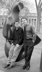 Jamie Heywood (right) quit his job in California to start a foundation to find a cure for ALS, a disease which is weakening his brother Stephen (left). Behind them is A Reclining Figure, a Killian Court sculpture that was a favorite of Jamie's during his student days at MIT. Their father is Professor John Heywood of mechanical engineering.
