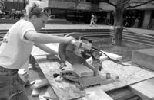 Rebecca Berry (SB 1995) saws wood to build for Habitat for Humanity.