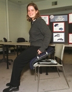 Mechanical engineering senior Aimee Angel of Portland, OR, who gradutes on Friday, June 2, demonstrates Power-Up, designed to assist people who have difficulty getting up from chairs.