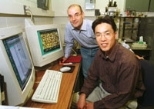 Claudio DeRosa (left) of the University of Naples and graduate student Cheolmin Park display examples of nanoscale patterns made using a process they developed.