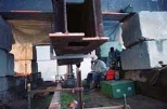 Inside the 200-ton test block, Rusty Brown (center) and Lance Mugford (far right) monitor test equipment calculating the load on the column and footing.
