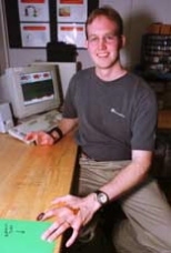 Stephen Mascaro, a graduate student in mechanical engineering, displays a fingernail sensor designed to replace input from a keyboard or mouse.