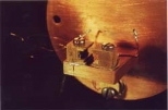 General Motors recently presented two historic lead-salt diode lasers to the MIT Museum. The lasers (about a quarter of an inch in length and a 32nd of an inch in diameter), mounted on tiny wires in the notched area of the copper pieces shown above, were used in historic experiments conducted at MIT Lincoln Laboratory in the early 1980s. The lasers will be on display through the end of October.