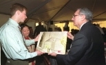 Two members of the student Founders Group for Simmons Hall present Richard Simmons (right) with an architectural sketch of the residence hall: Jeffrey Roberts (left), president of the Dormitory Council and a junior in urban studies and planning, and Tina Lin (center), co-chair of the Undergraduate Association Committee and a junior in architecture.