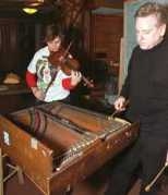 Composer and IAP artist-in-residence          Arnold Dreyblatt teaches a new tuning system to violinist          Lauren Smith during a rehearsal in the Endicott World Music          Center. Ms. Smith is tuning her violin to Mr. Dreyblatt's          "instrument," the frame and strings of a miniature piano          from the 1930s.