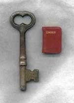 The key measures 2 and 9/16 inches high. The book is 13/16 of an inch high by 9/16 of an inch wide.