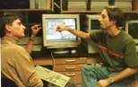 Professor Jesus del Alamo (left) converses with electrical engineering junior James Hardison in front of the WebLab system in Professor del Alamo's lab.